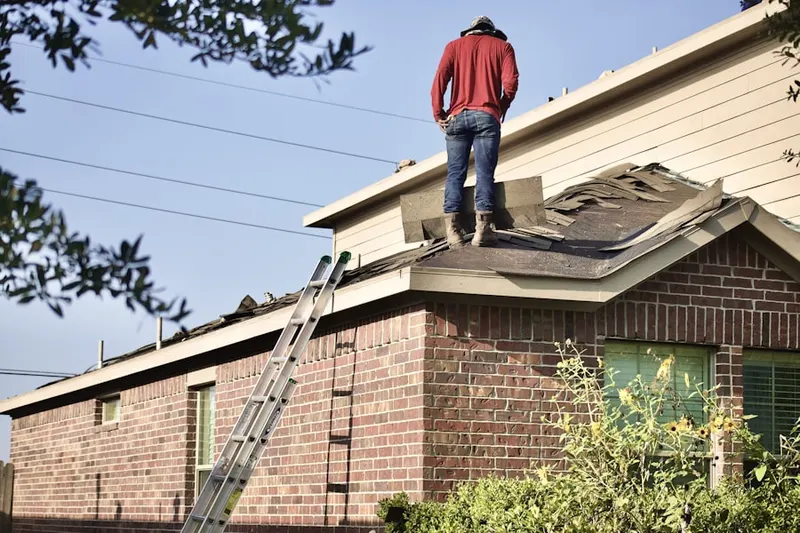 Professional roofer working on a residential roof in Taft